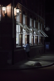 Woman looking into bright windows